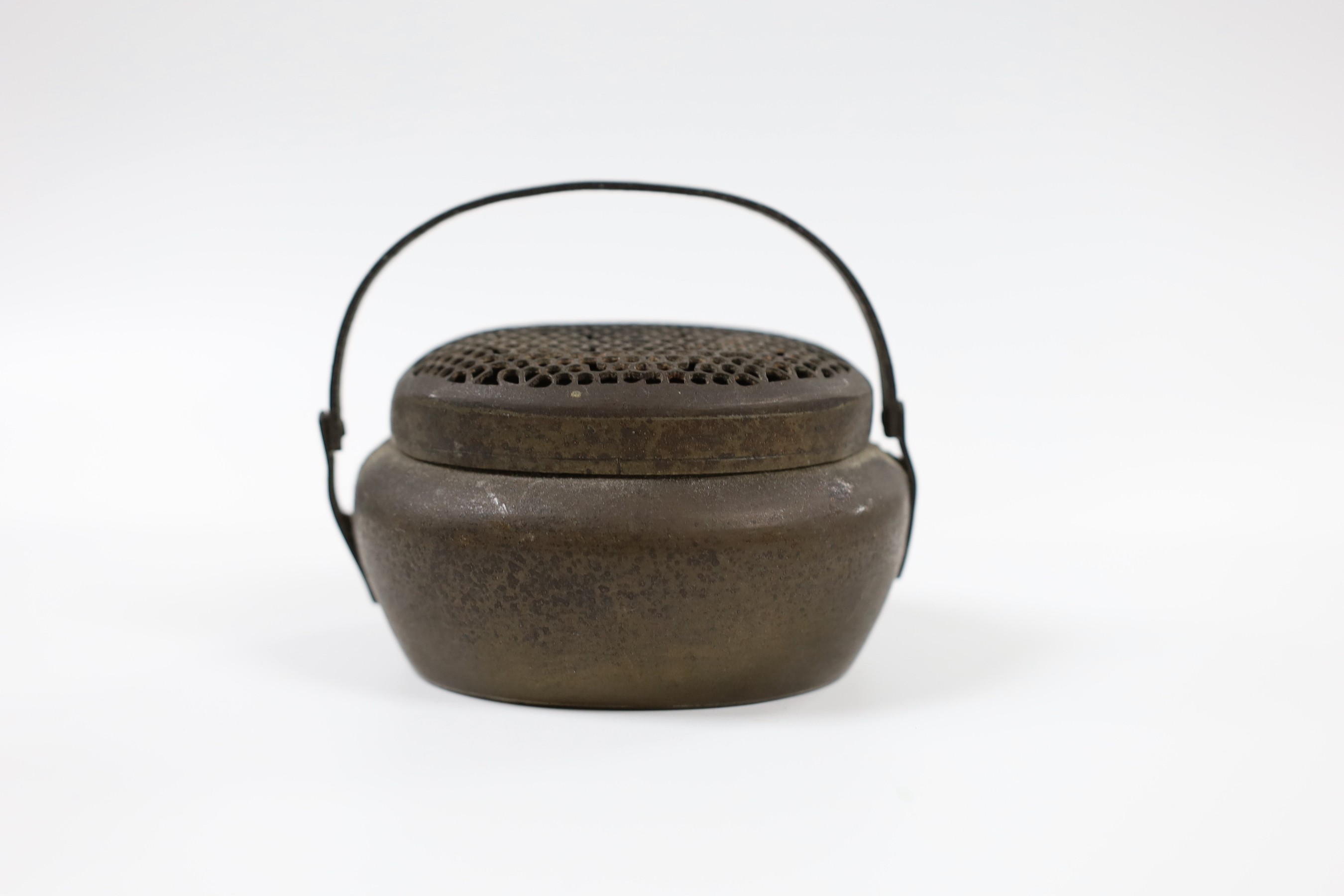 A Chinese bronze hand warmer, together with an inscribed inkstick, 16cm wide, and a hardstone carving